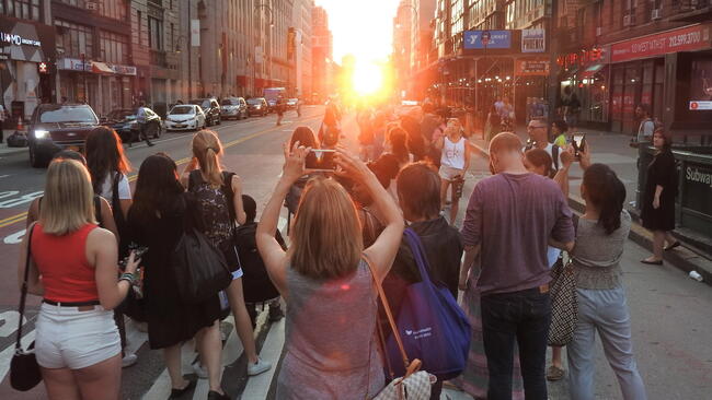 A group admires the final moments of Manhattenhenge 2019.