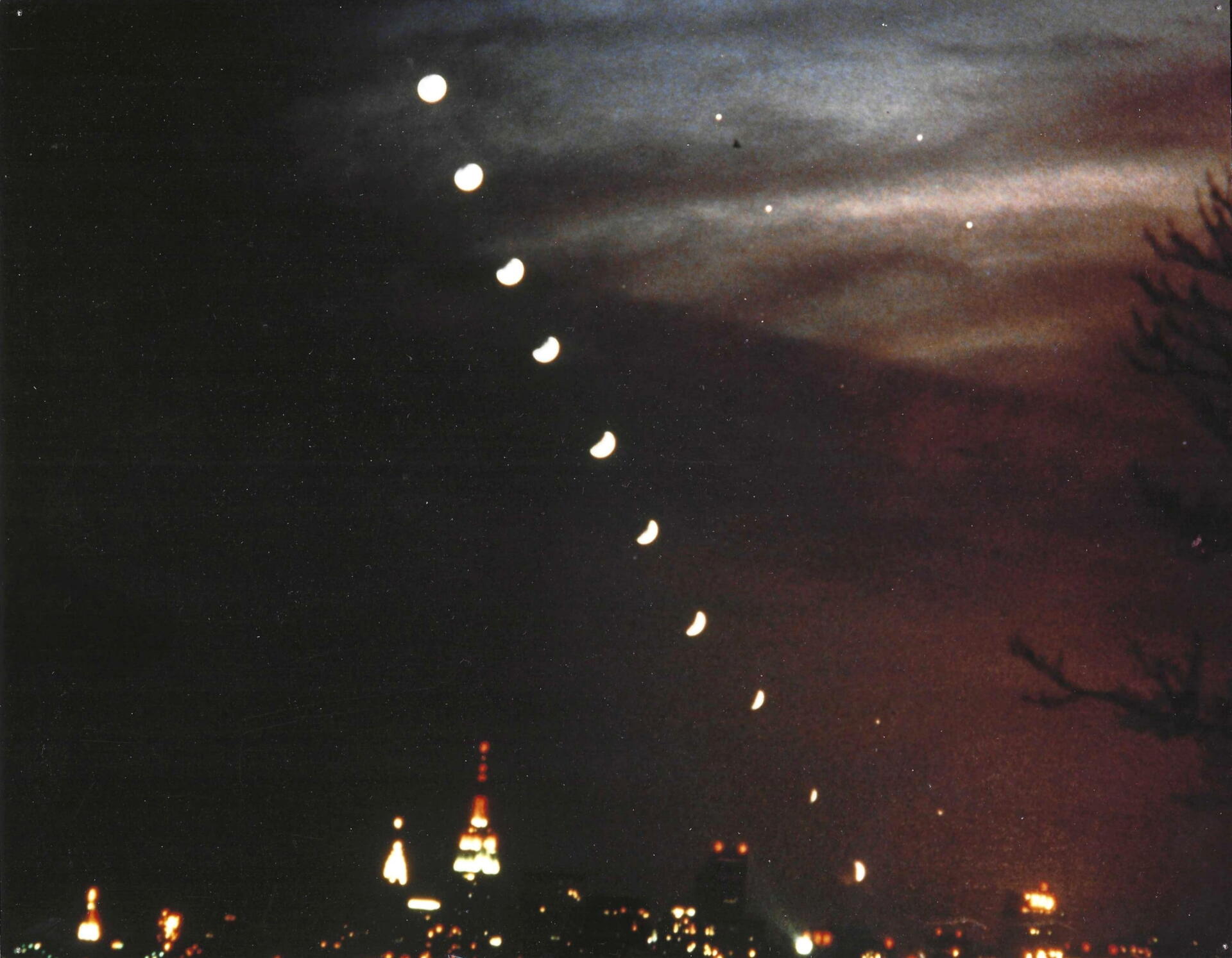 Composite image showing the Moon moving into Earth’s shadow as it sets over the Manhattan skyline. Photo by Joe Rao.