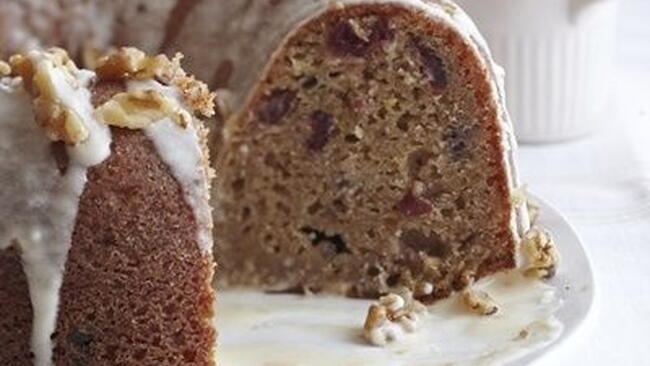 sliced cross-section of cranberry beet cake with orange walnut glaze