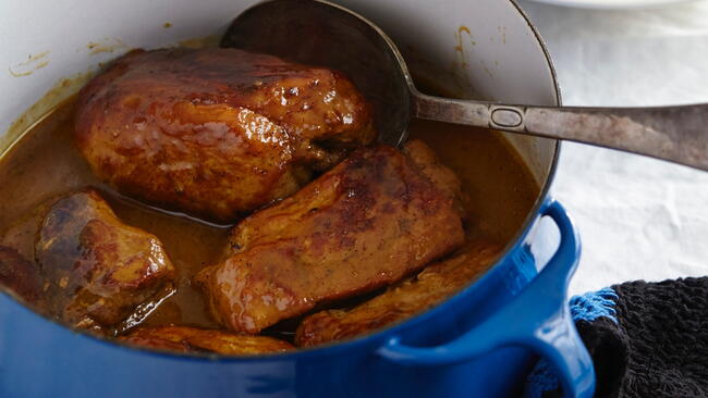 Juicy pork strips in a blue pot 